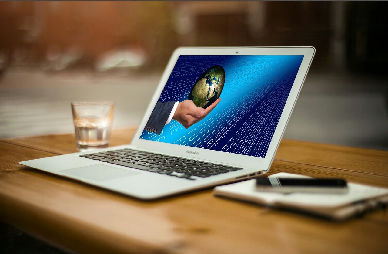 Starting a Podcast Hand Holding a Globe on Laptop